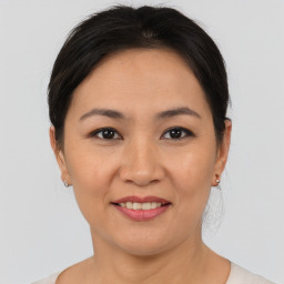 Joyful asian young-adult female with short  brown hair and brown eyes