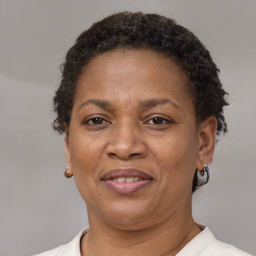 Joyful black adult female with short  brown hair and brown eyes