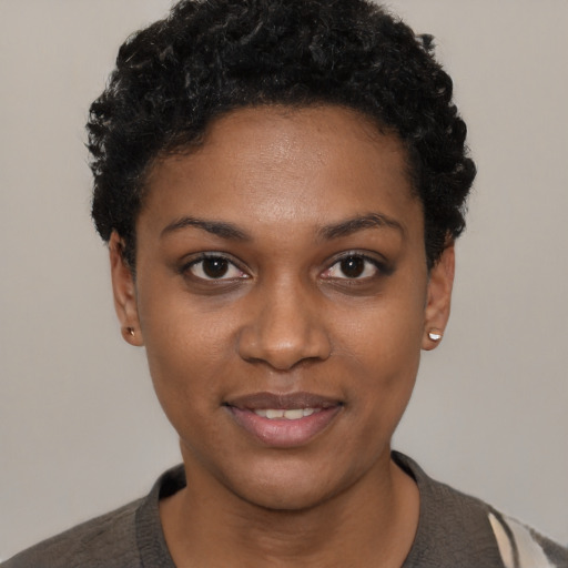 Joyful black young-adult female with short  black hair and brown eyes