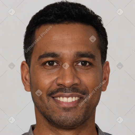 Joyful latino young-adult male with short  black hair and brown eyes