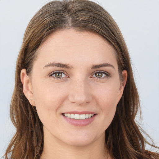 Joyful white young-adult female with long  brown hair and grey eyes