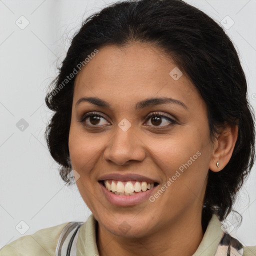 Joyful latino young-adult female with medium  brown hair and brown eyes