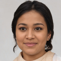 Joyful latino young-adult female with medium  brown hair and brown eyes