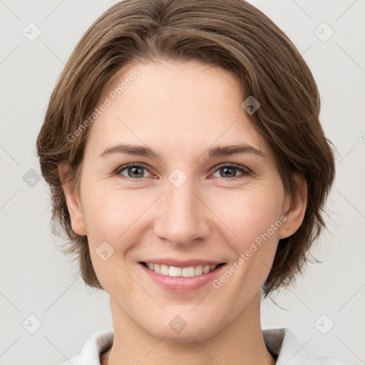 Joyful white young-adult female with medium  brown hair and grey eyes