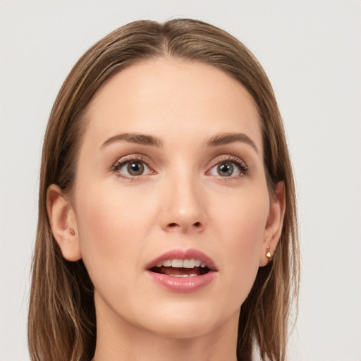 Joyful white young-adult female with long  brown hair and grey eyes