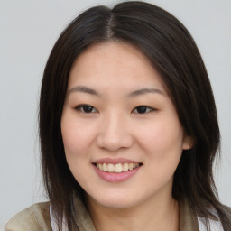 Joyful asian young-adult female with long  brown hair and brown eyes