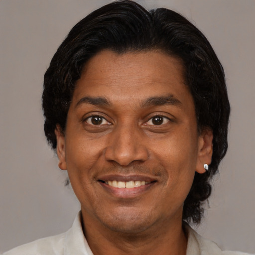 Joyful latino adult male with short  brown hair and brown eyes