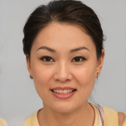 Joyful asian young-adult female with short  brown hair and brown eyes