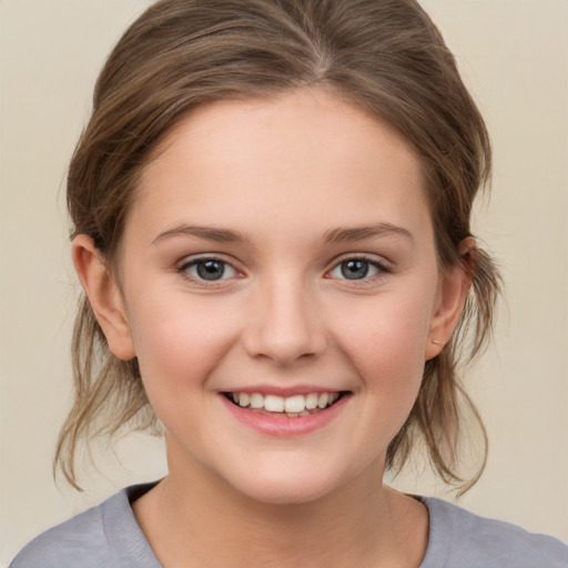 Joyful white child female with medium  brown hair and grey eyes