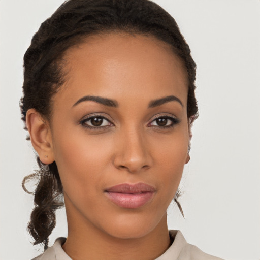 Joyful latino young-adult female with medium  brown hair and brown eyes