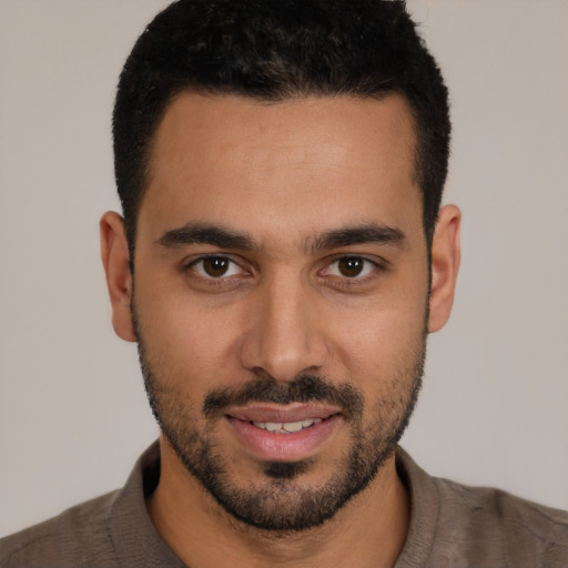 Joyful white young-adult male with short  black hair and brown eyes