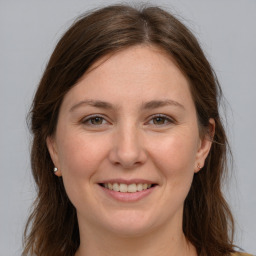 Joyful white young-adult female with long  brown hair and brown eyes