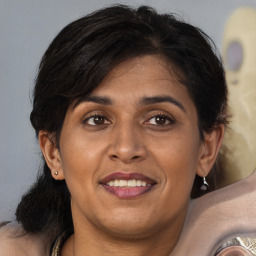 Joyful white adult female with medium  brown hair and brown eyes