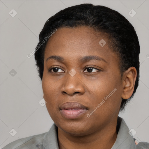 Joyful black young-adult female with short  black hair and brown eyes