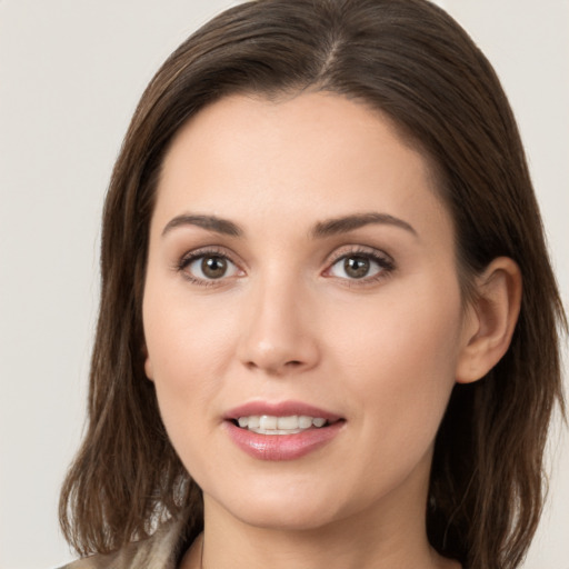 Joyful white young-adult female with long  brown hair and brown eyes