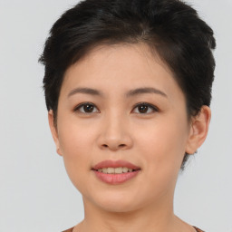 Joyful asian young-adult female with short  brown hair and brown eyes