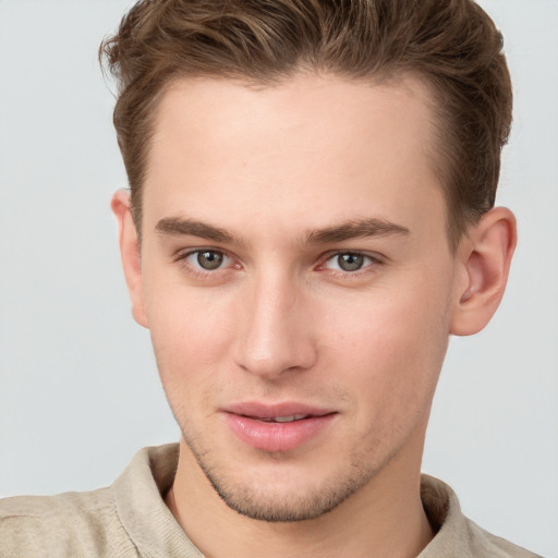 Joyful white young-adult male with short  brown hair and grey eyes