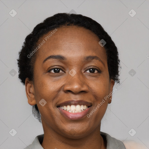 Joyful black adult female with short  black hair and brown eyes