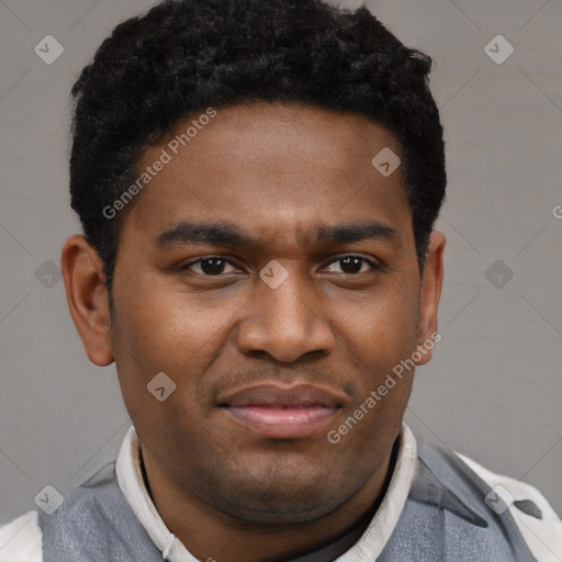 Joyful black young-adult male with short  brown hair and brown eyes