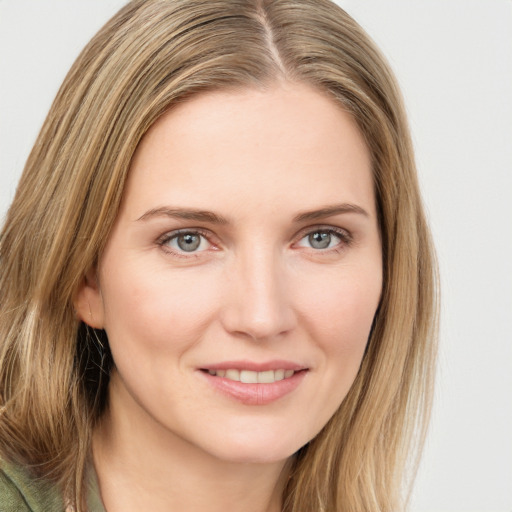 Joyful white young-adult female with long  brown hair and green eyes