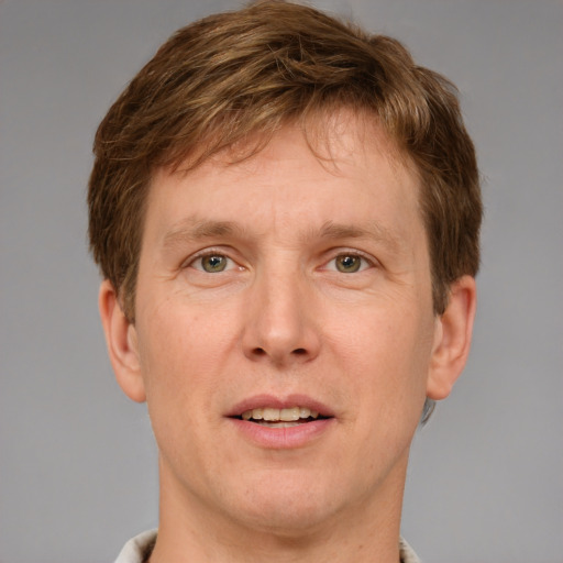 Joyful white adult male with short  brown hair and grey eyes