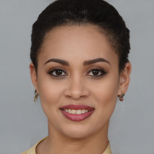 Joyful latino young-adult female with short  brown hair and brown eyes
