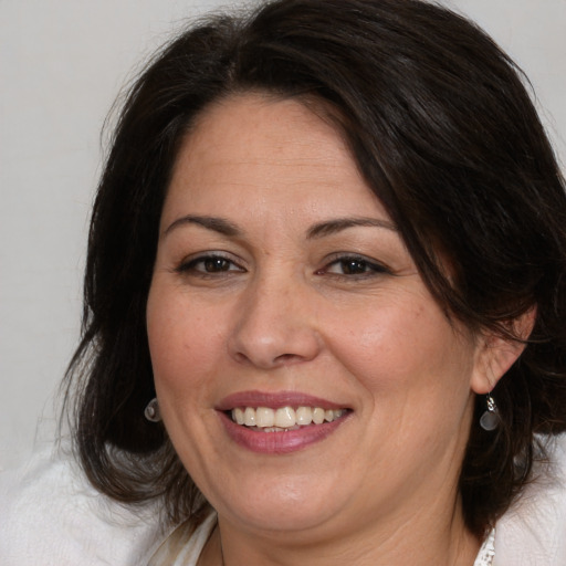 Joyful white adult female with medium  brown hair and brown eyes