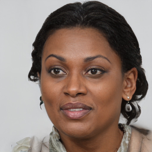 Joyful black adult female with medium  brown hair and brown eyes