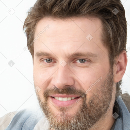 Joyful white adult male with short  brown hair and grey eyes