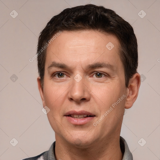 Joyful white adult male with short  brown hair and grey eyes