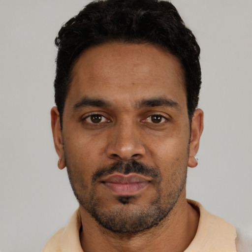 Neutral latino young-adult male with short  black hair and brown eyes