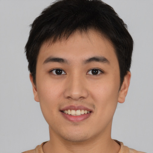Joyful asian young-adult male with short  brown hair and brown eyes