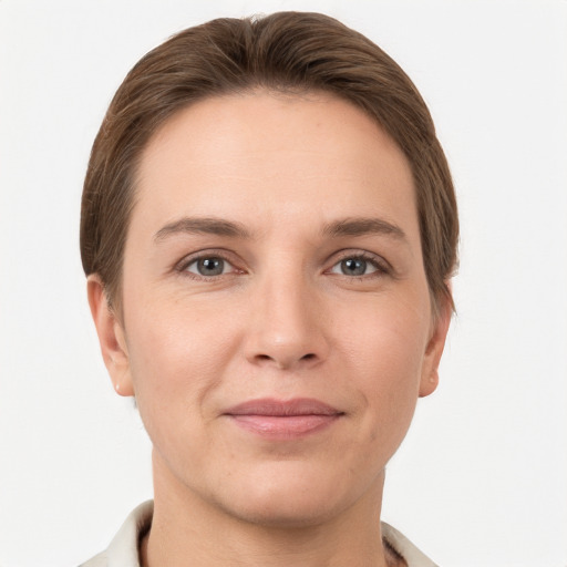 Joyful white young-adult female with short  brown hair and grey eyes