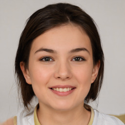 Joyful white young-adult female with medium  brown hair and brown eyes