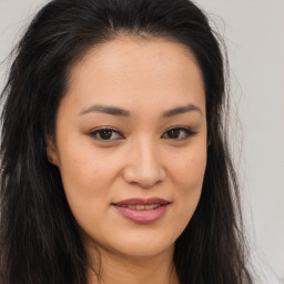 Joyful asian young-adult female with long  brown hair and brown eyes