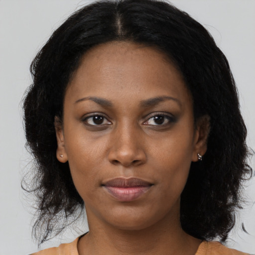 Neutral black young-adult female with medium  brown hair and brown eyes