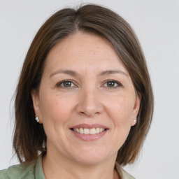 Joyful white adult female with medium  brown hair and brown eyes