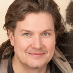 Joyful white adult male with medium  brown hair and blue eyes