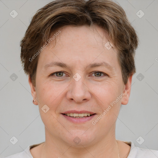 Joyful white adult female with short  brown hair and grey eyes