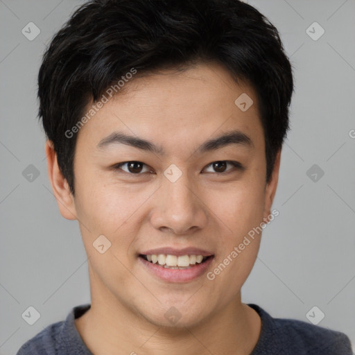 Joyful asian young-adult male with short  brown hair and brown eyes