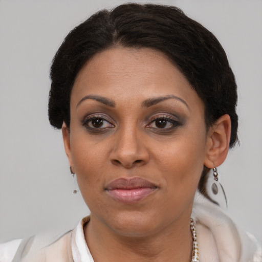 Joyful latino adult female with short  brown hair and brown eyes