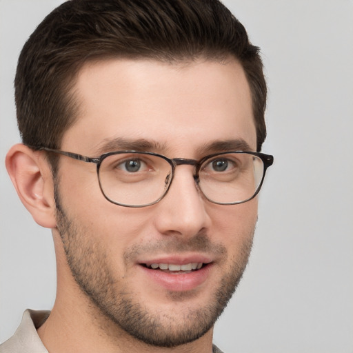 Joyful white young-adult male with short  brown hair and grey eyes