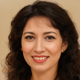 Joyful white adult female with long  brown hair and brown eyes