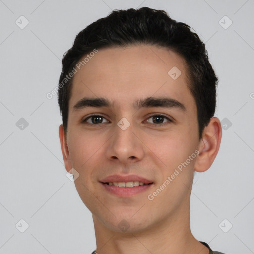 Joyful white young-adult male with short  black hair and brown eyes