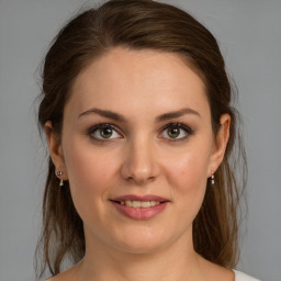 Joyful white young-adult female with medium  brown hair and brown eyes