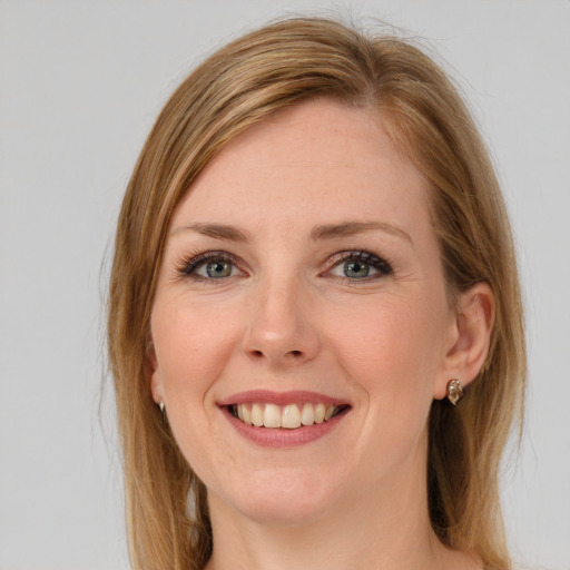 Joyful white young-adult female with long  brown hair and green eyes