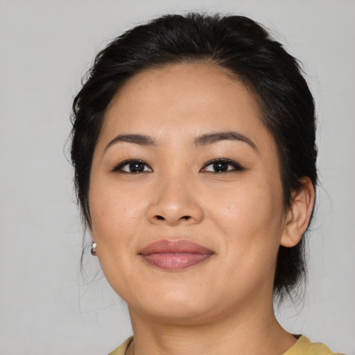 Joyful asian young-adult female with medium  black hair and brown eyes