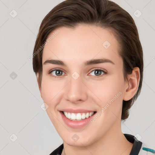 Joyful white young-adult female with medium  brown hair and grey eyes