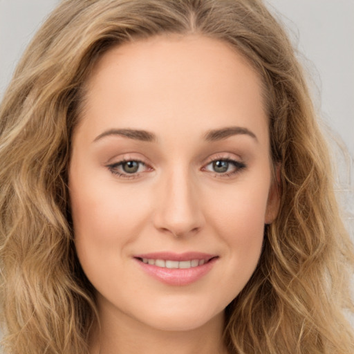 Joyful white young-adult female with long  brown hair and green eyes