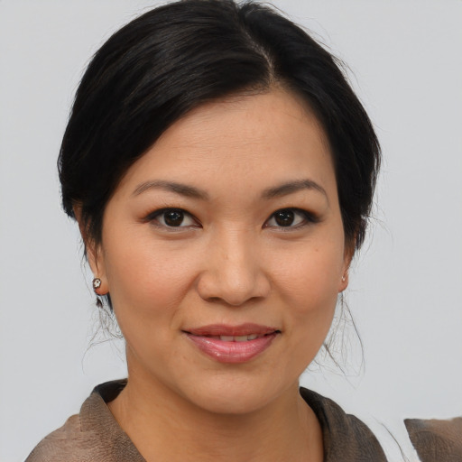 Joyful asian young-adult female with medium  brown hair and brown eyes